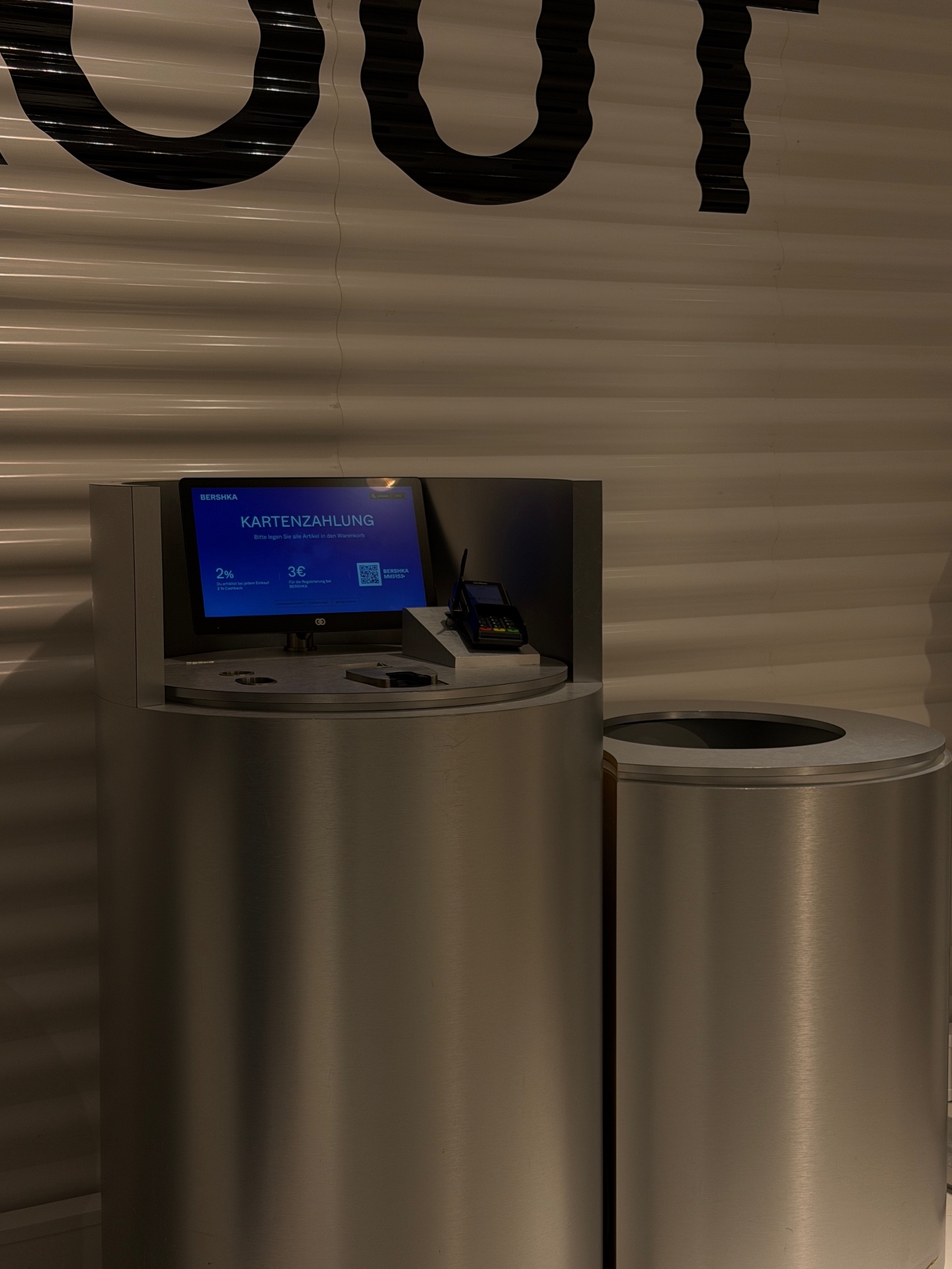 Before: the original colour photograph of a metal checkout station